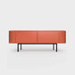 Curved Desiva Enna 01 lowboard in brick orange color steel, available in Switzerland via ÉTAUDORÉ